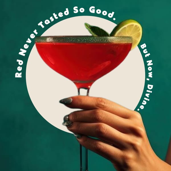 Hand holding a red cocktail with a lime wedge and mint garnish, against a green background.
